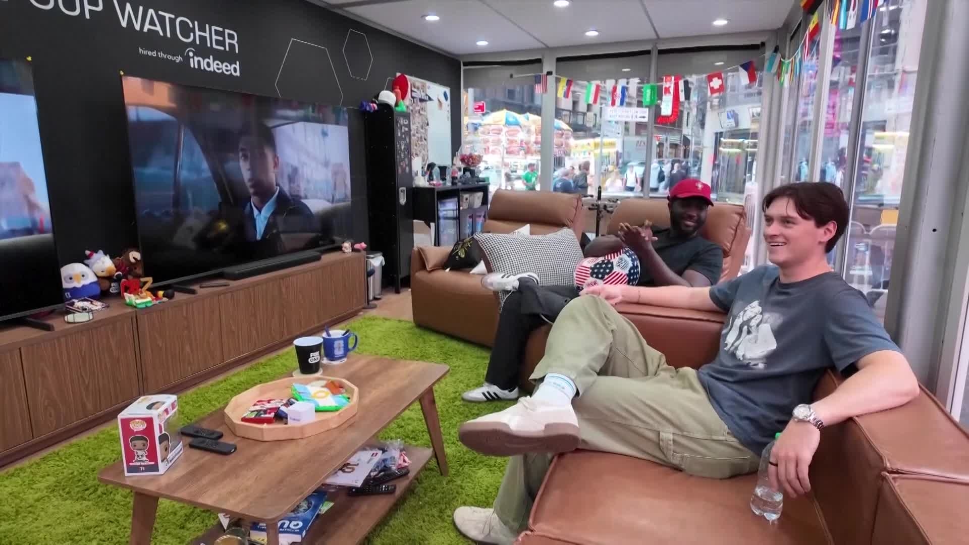 the-ultimate-watch-party-meet-the-soccer-superfans-being-paid-to-watch-all-104-fifa-world-cup-games-from-inside-a-times-square-glass-cube